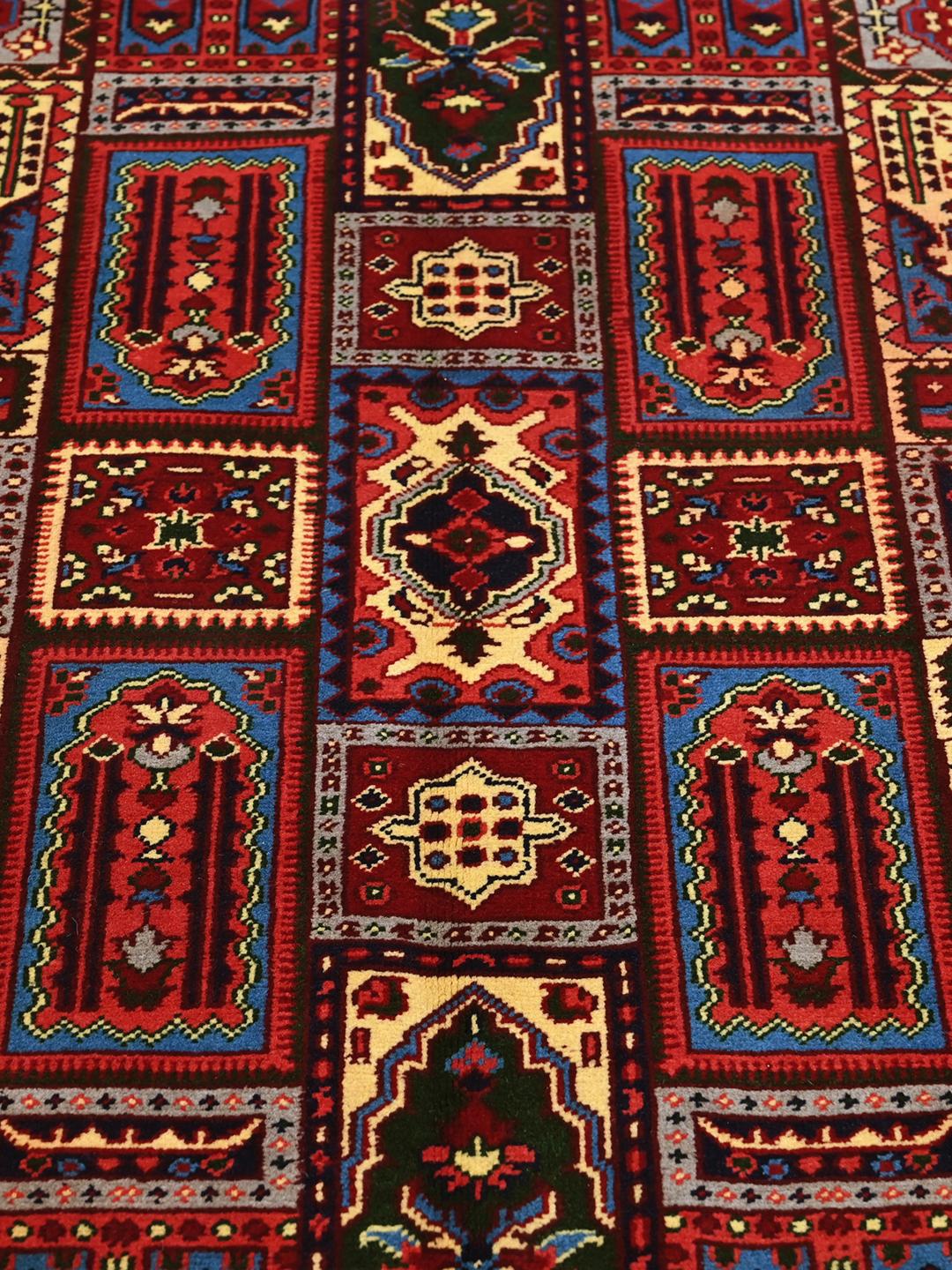 Hand-knotted Kunduz rug from Afghanistan in dark-red and multicolour tones