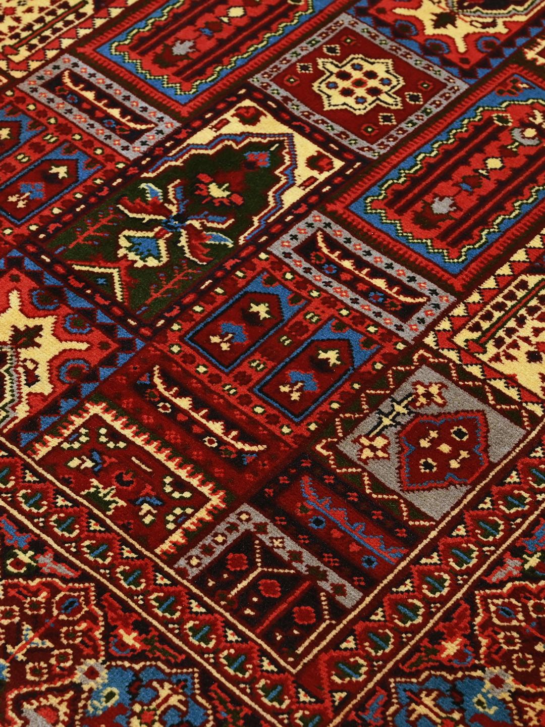 Hand-knotted Kunduz rug from Afghanistan in dark-red and multicolour tones