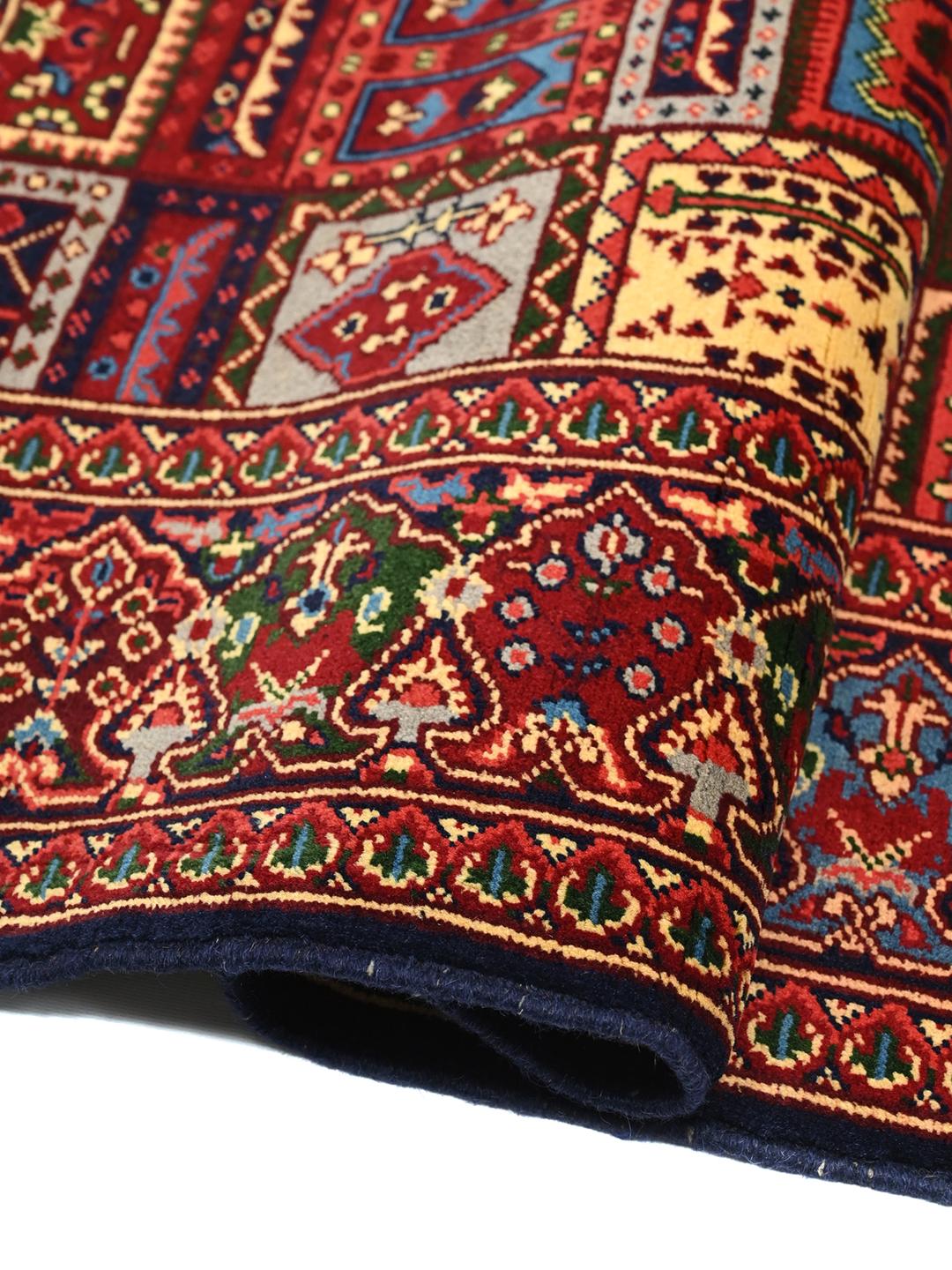 Hand-knotted Kunduz rug from Afghanistan in dark-red and multicolour tones