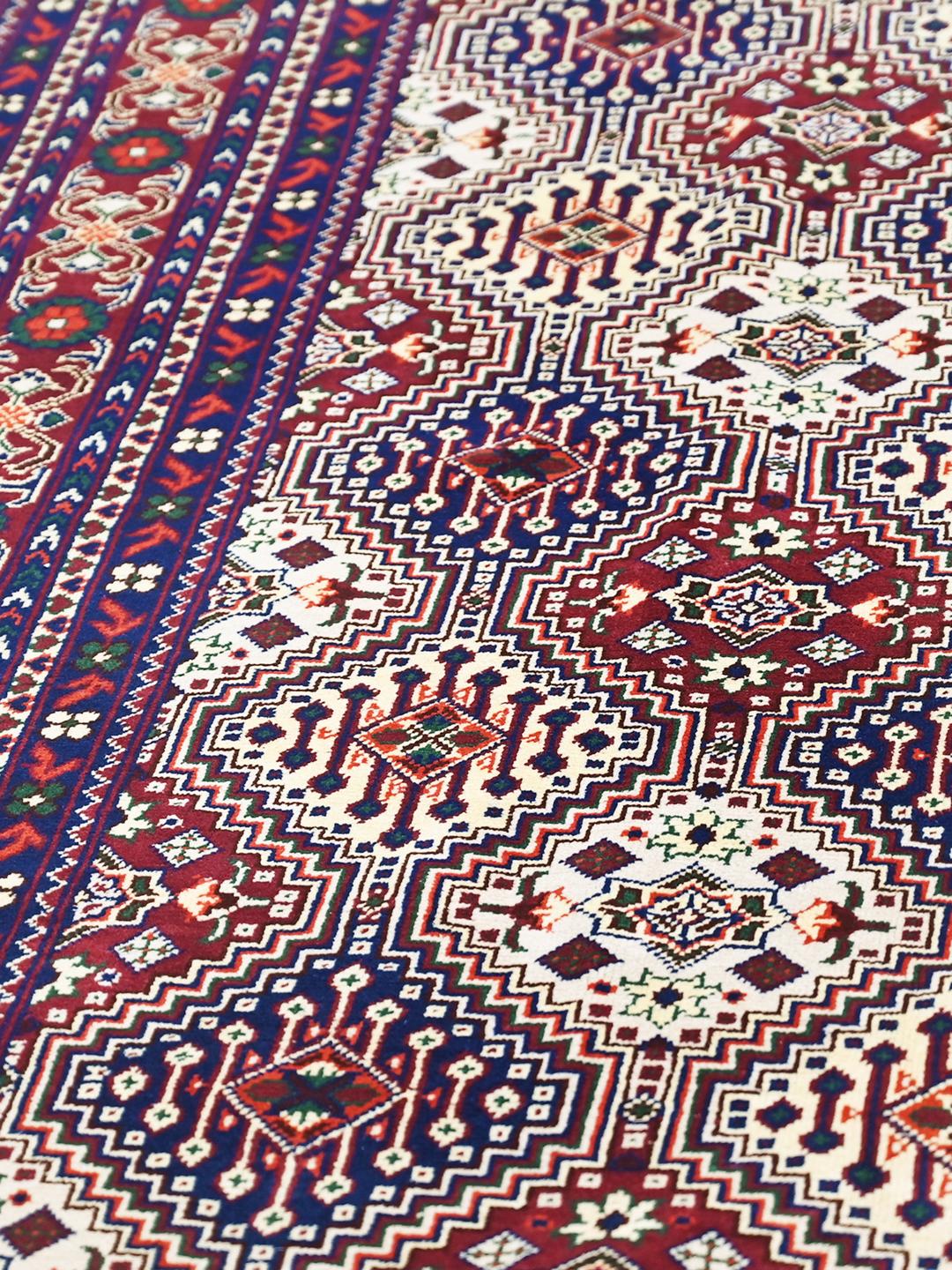 Hand-knotted red Afghan Kunduz rug with geometric patterns