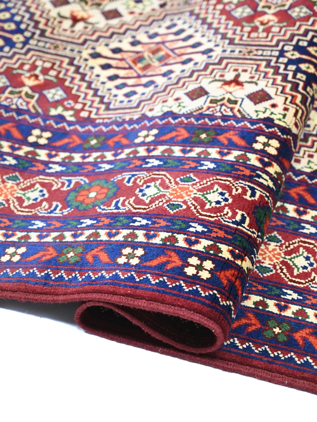 Hand-knotted red Afghan Kunduz rug with geometric patterns