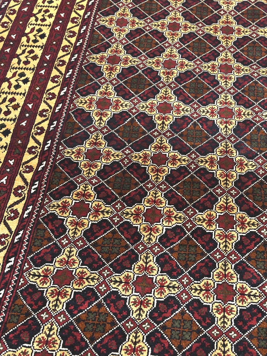 Hand-knotted Kunduz rug from the Middle East with a dark-red and beige geometric pattern.