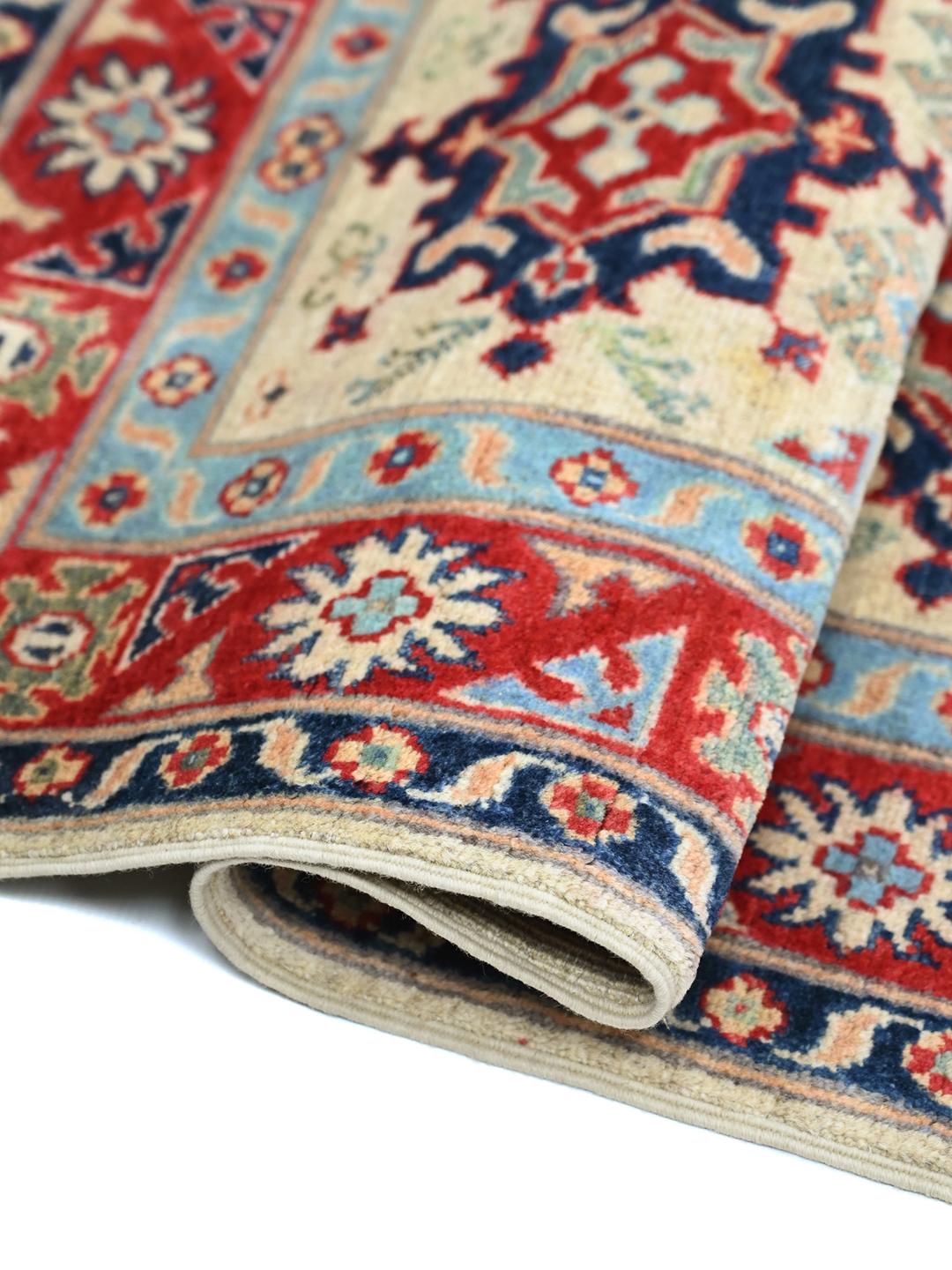 Hand-knotted Afghan Kazak Fine rug in red and blue featuring traditional tribal medallions