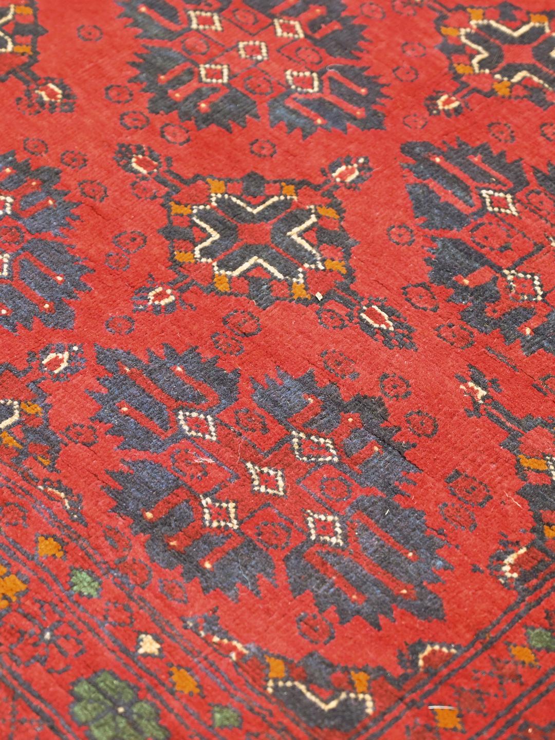 Hand-knotted Afghan Khal Mohammadi rug in red and dark-blue