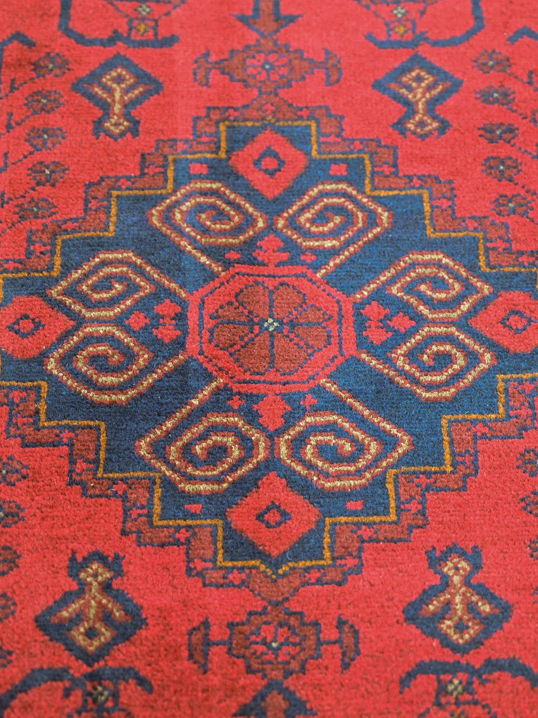Hand-knotted Afghan Khal Mohammadi rug in red and black