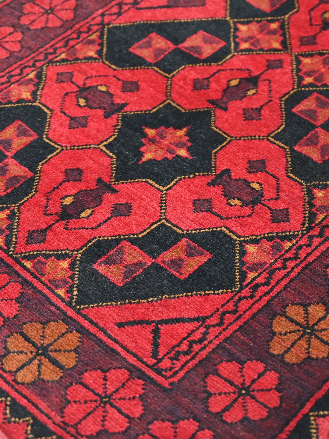 Hand-knotted Afghan Khal Mohammadi rug in red and black