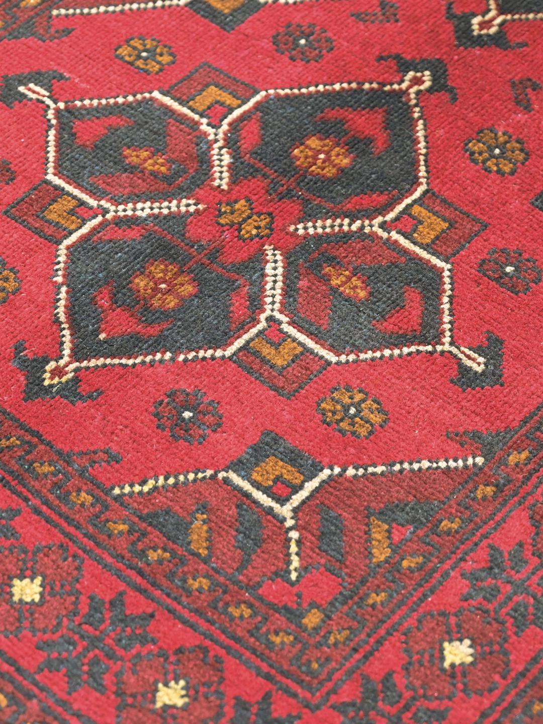 Hand-knotted red Afghan Khal Mohammadi wool rug with dark-grey medallions
