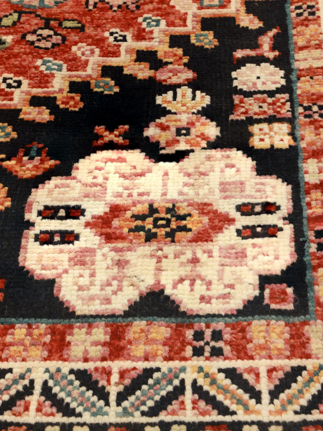 Handmade Kazak rug from Afghanistan in dark-grey and red