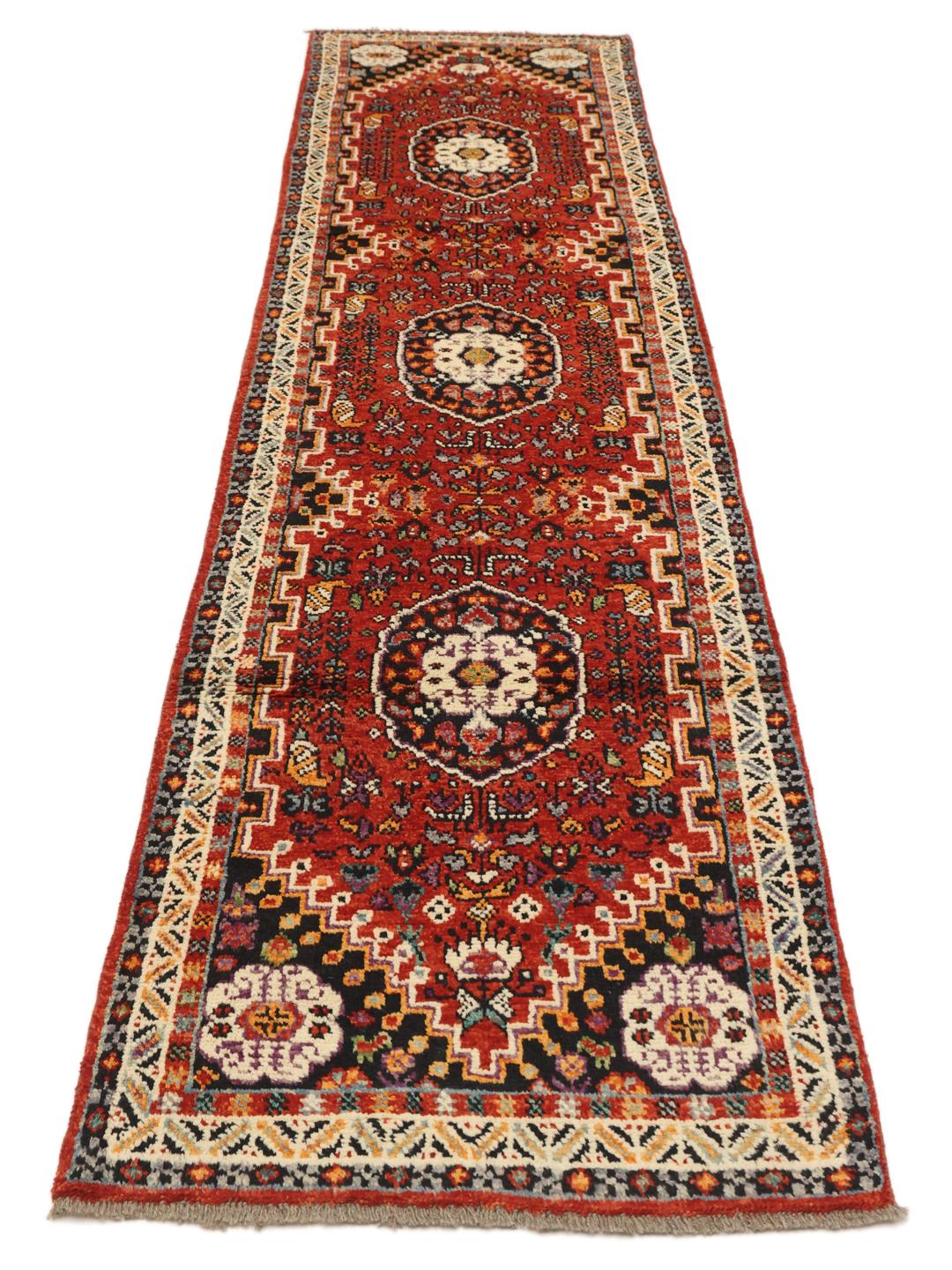 Red Afghan Kazak runner with geometric patterns