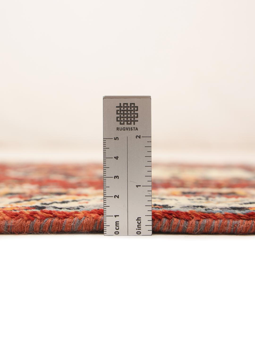 Red Afghan Kazak runner with geometric patterns