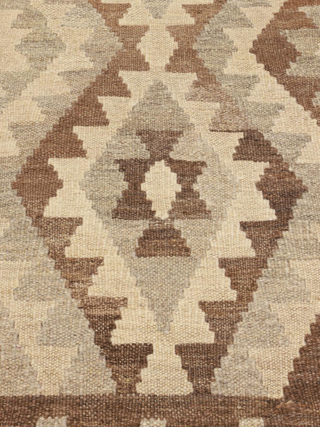 Handmade brown Afghan Kelim rug with geometric pattern
