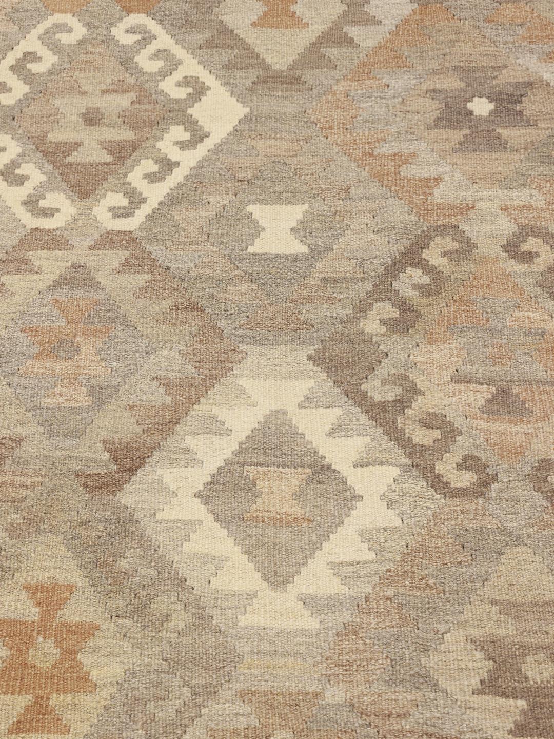 Handmade Afghan rug with geometric diamond patterns in brown and beige