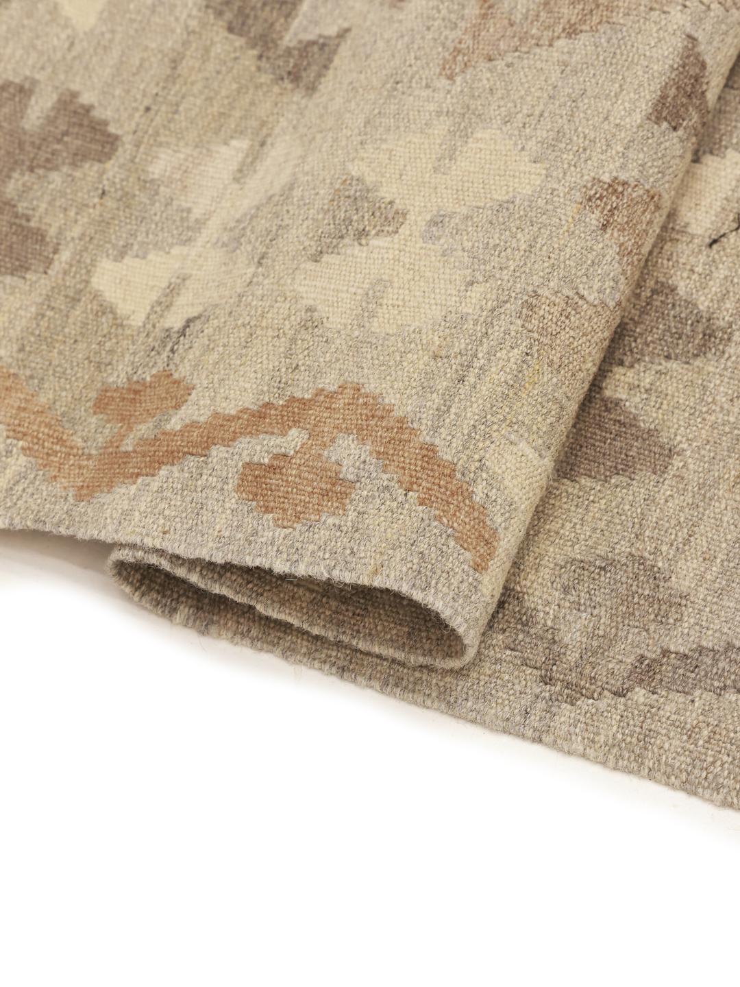 Handmade Afghan rug with geometric diamond patterns in brown and beige