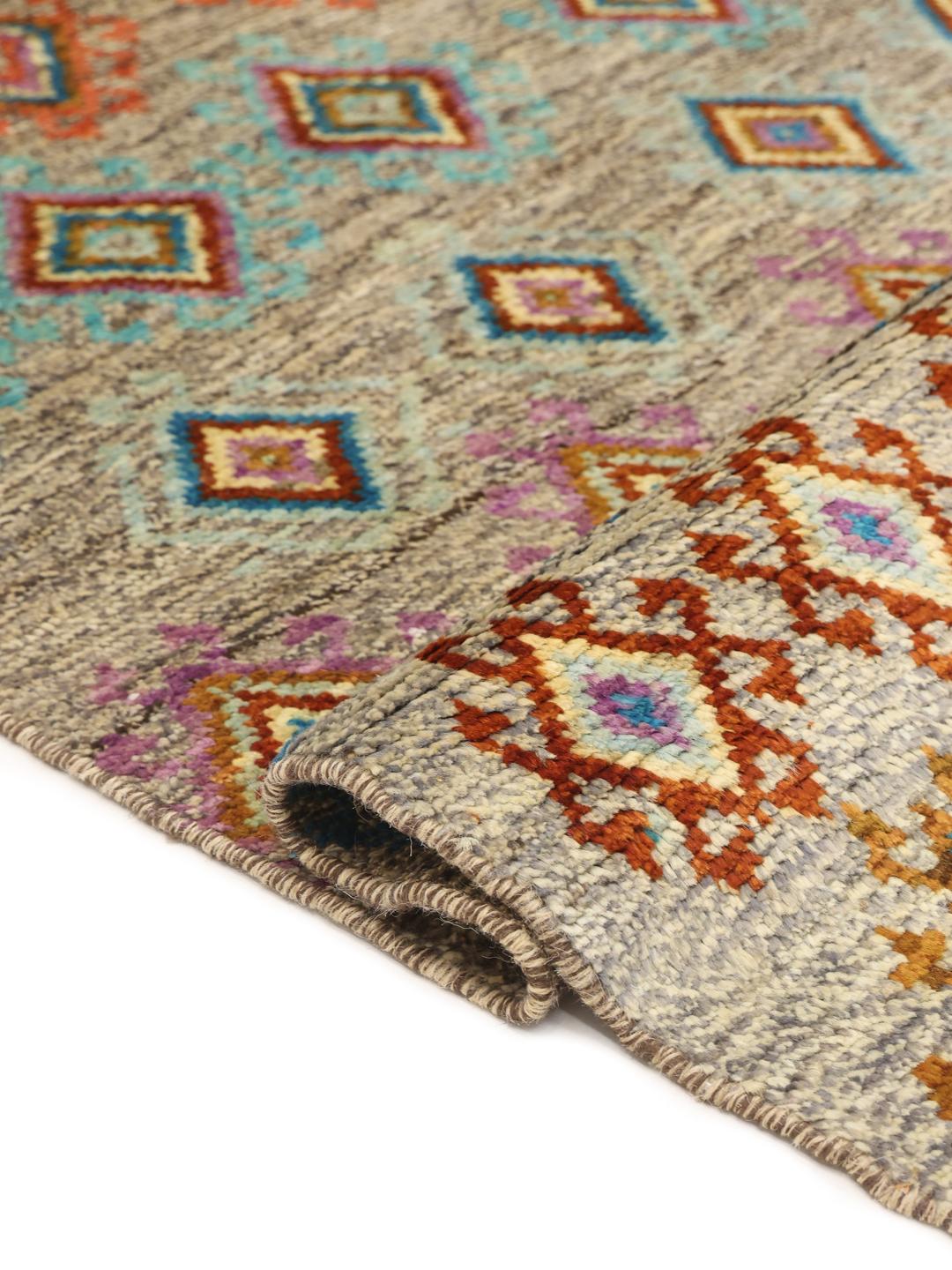 Hand-knotted Afghan rug with colourful geometric patterns on a grey background