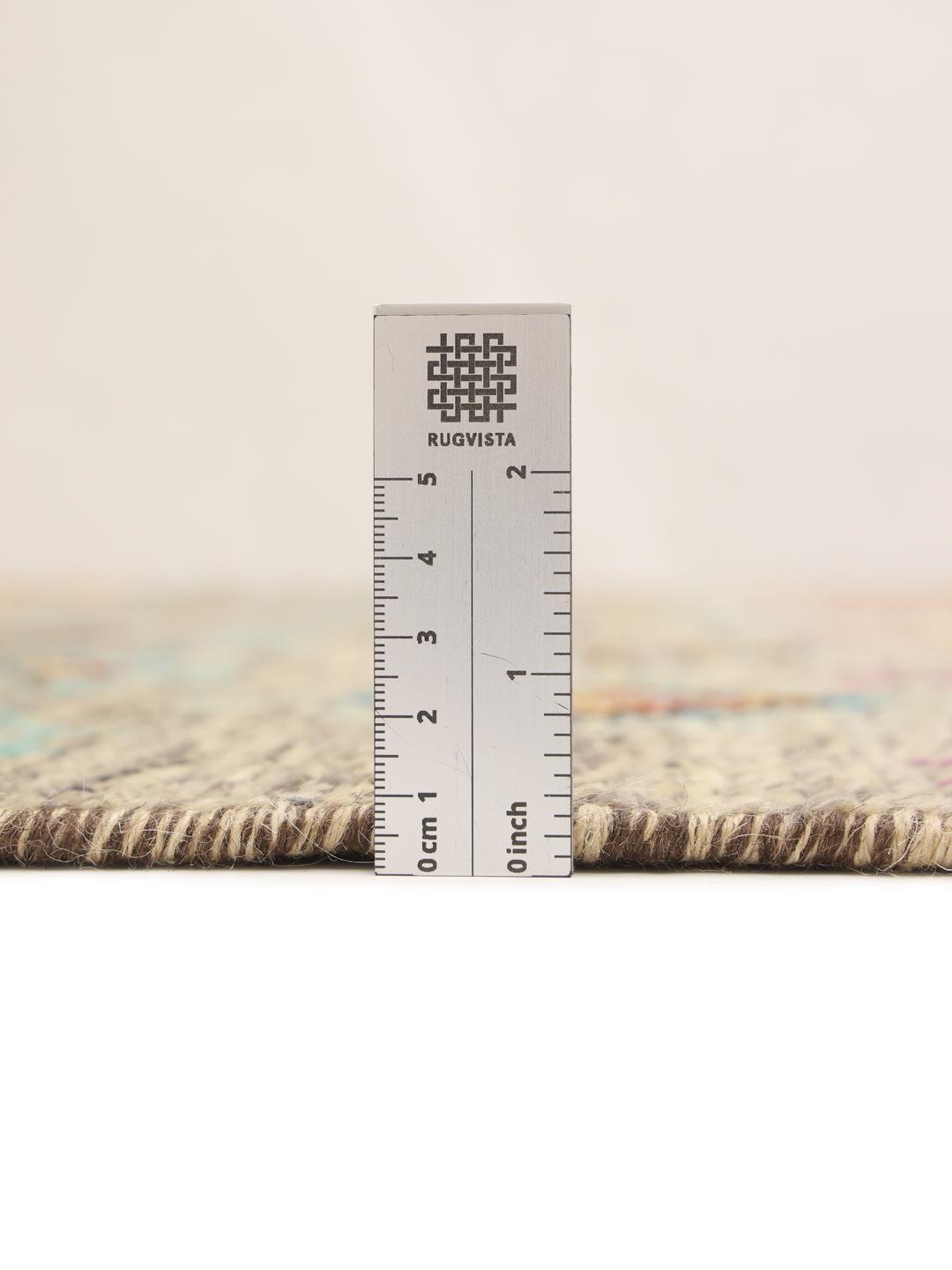 Hand-knotted Afghan rug with colourful geometric patterns on a grey background