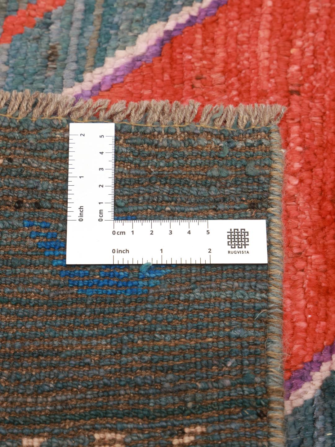 Handmade wool rug from Afghanistan in teal with colorful diamond patterns