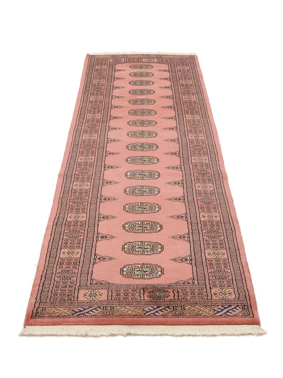Red runner rug from Pakistan with traditional motifs