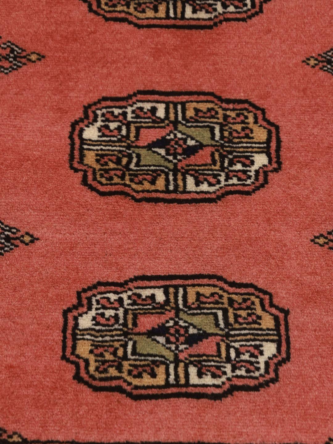 Red runner rug from Pakistan with traditional motifs