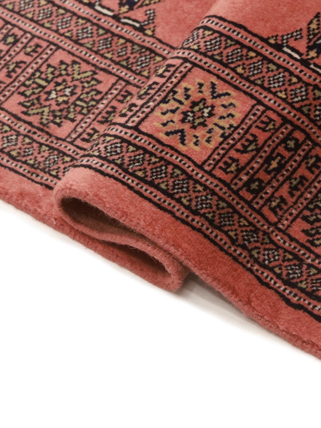 Red runner rug from Pakistan with traditional motifs