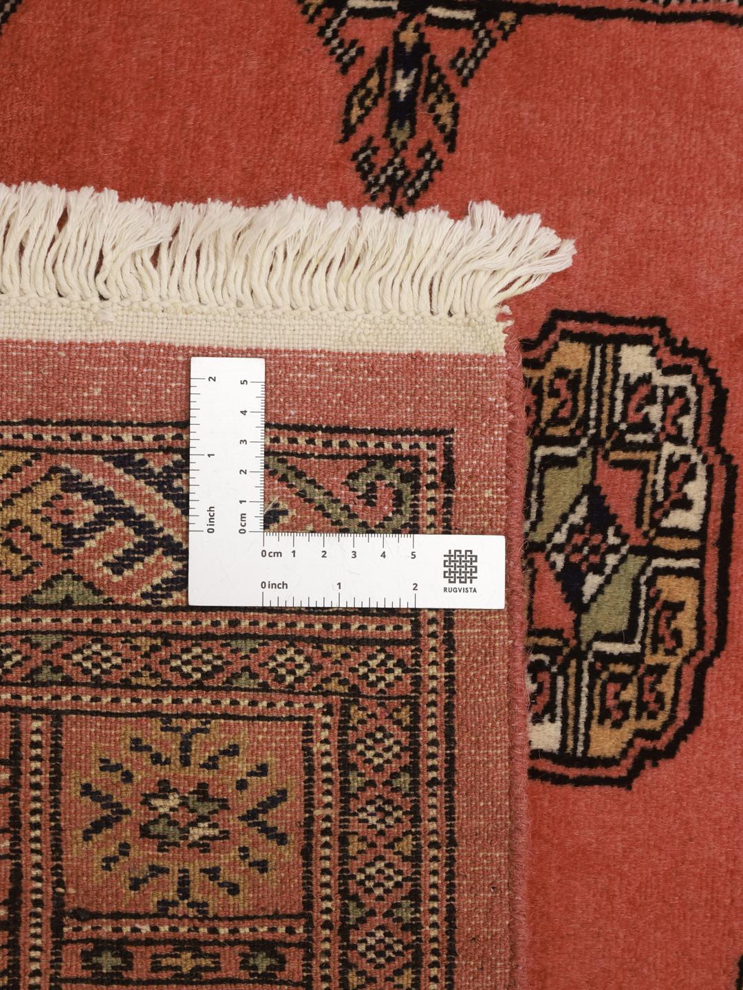 Red runner rug from Pakistan with traditional motifs
