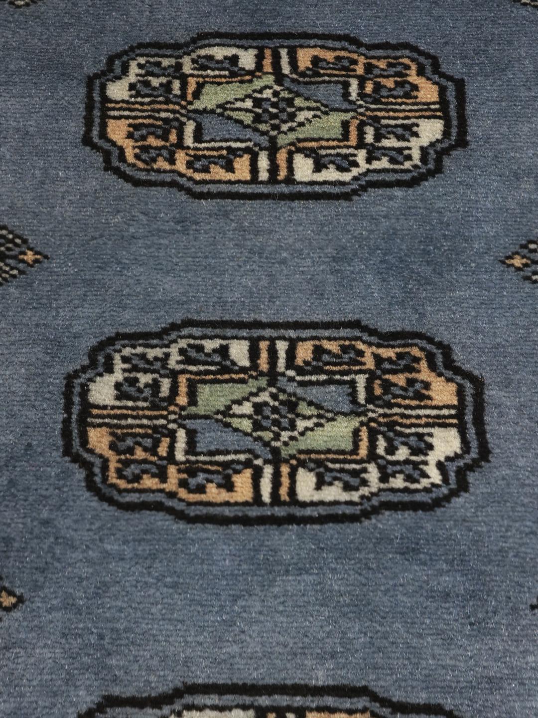 Handmade Pakistan Bokhara blue rug with traditional motifs