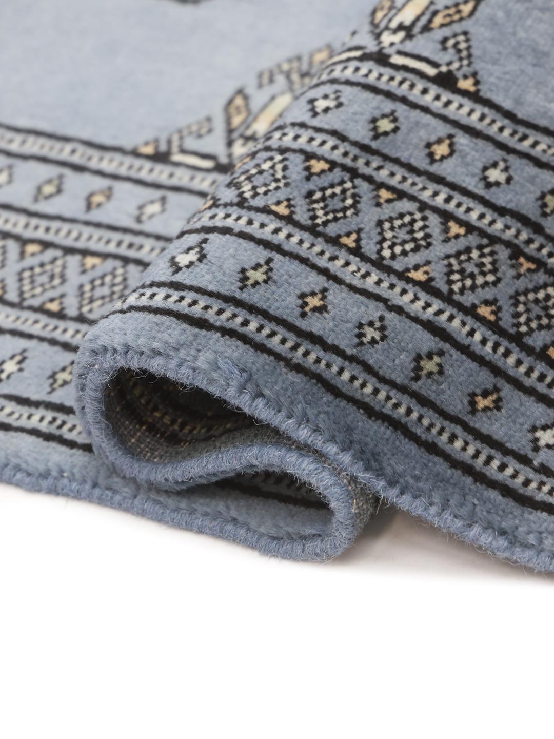 Handmade Pakistan Bokhara blue rug with traditional motifs