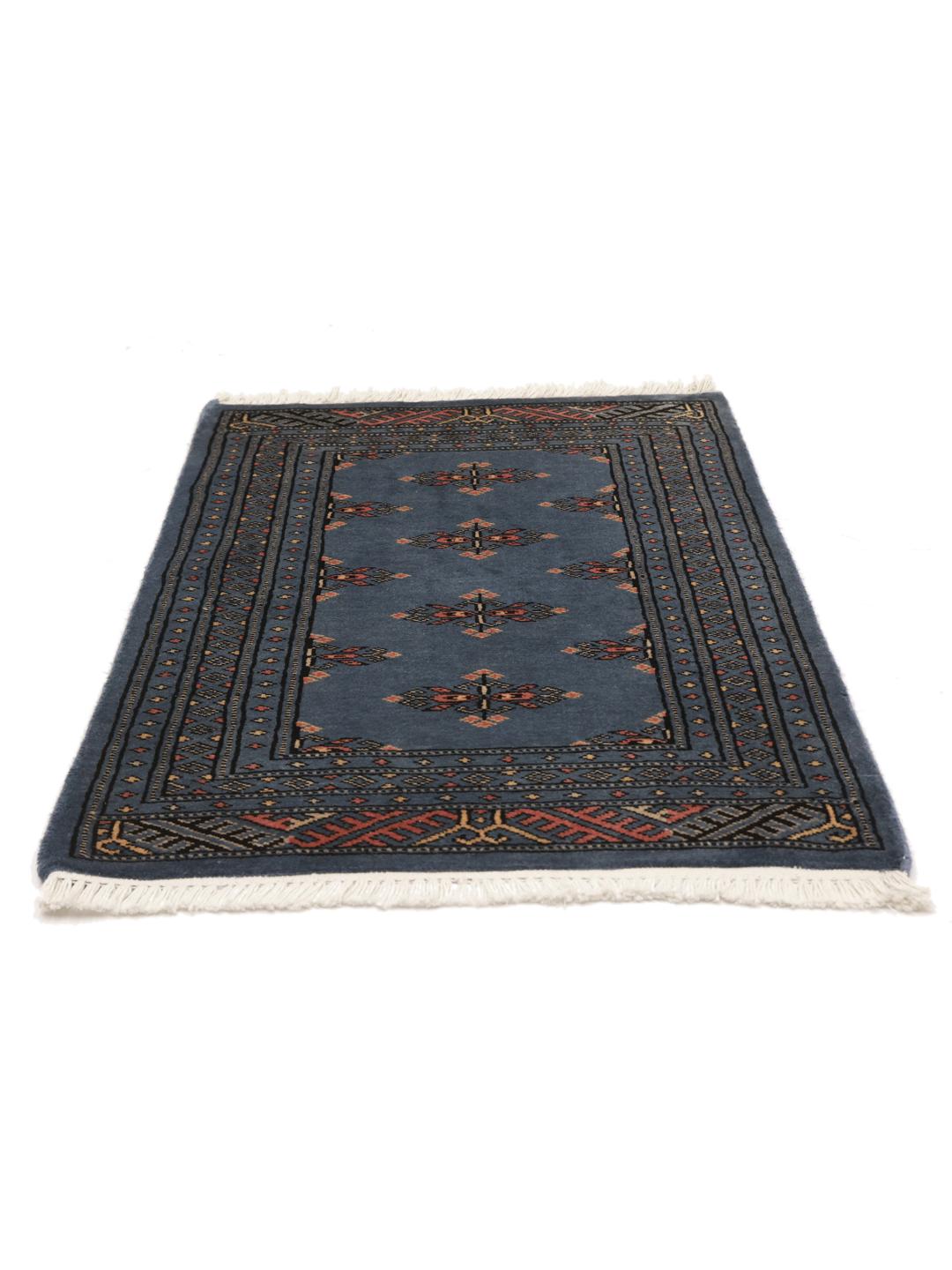 Handmade blue Pakistani rug with traditional motifs