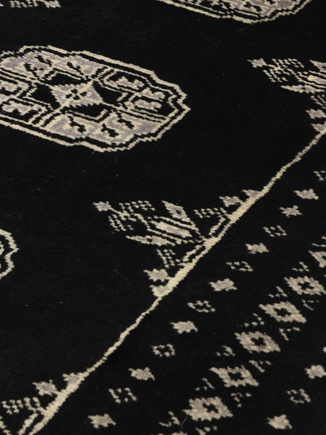 Hand-knotted Pakistan wool rug in black with traditional motifs