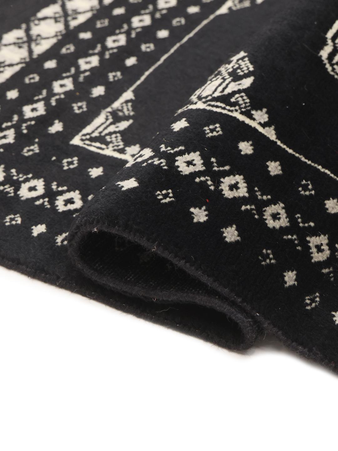 Hand-knotted Pakistan wool rug in black with traditional motifs