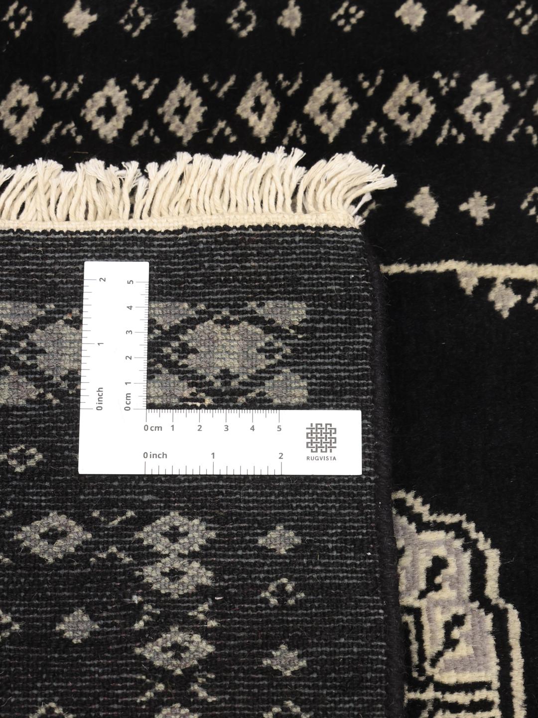 Hand-knotted Pakistan wool rug in black with traditional motifs