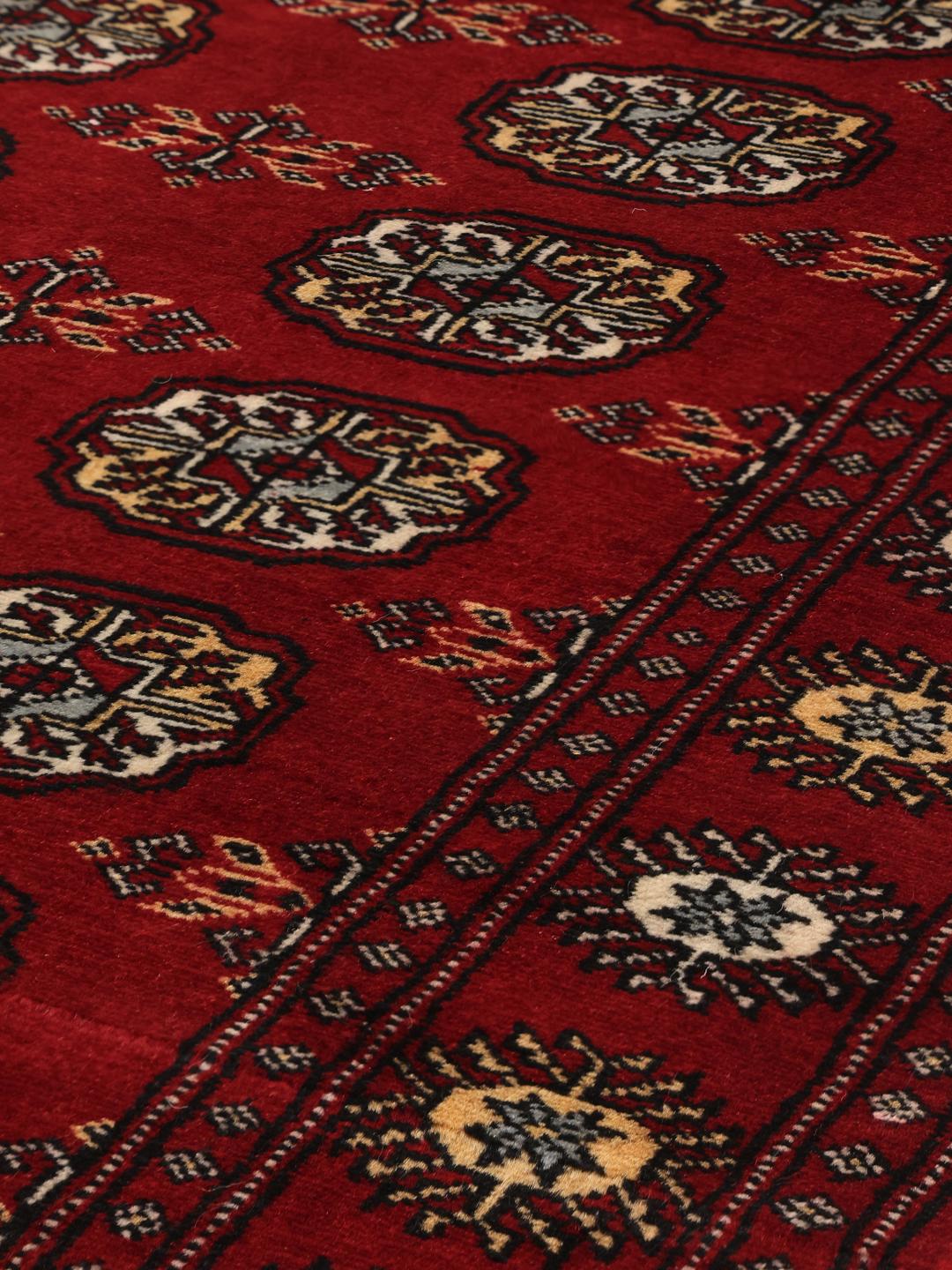Handmade Pakistan red rug with traditional motifs