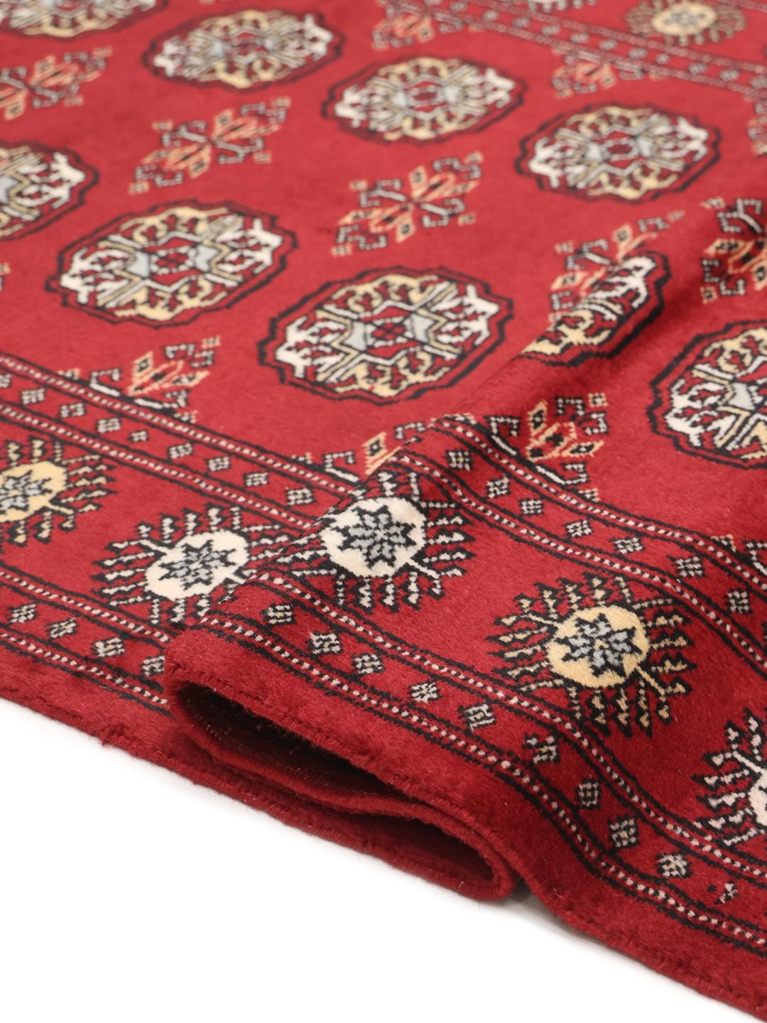 Handmade Pakistan red rug with traditional motifs