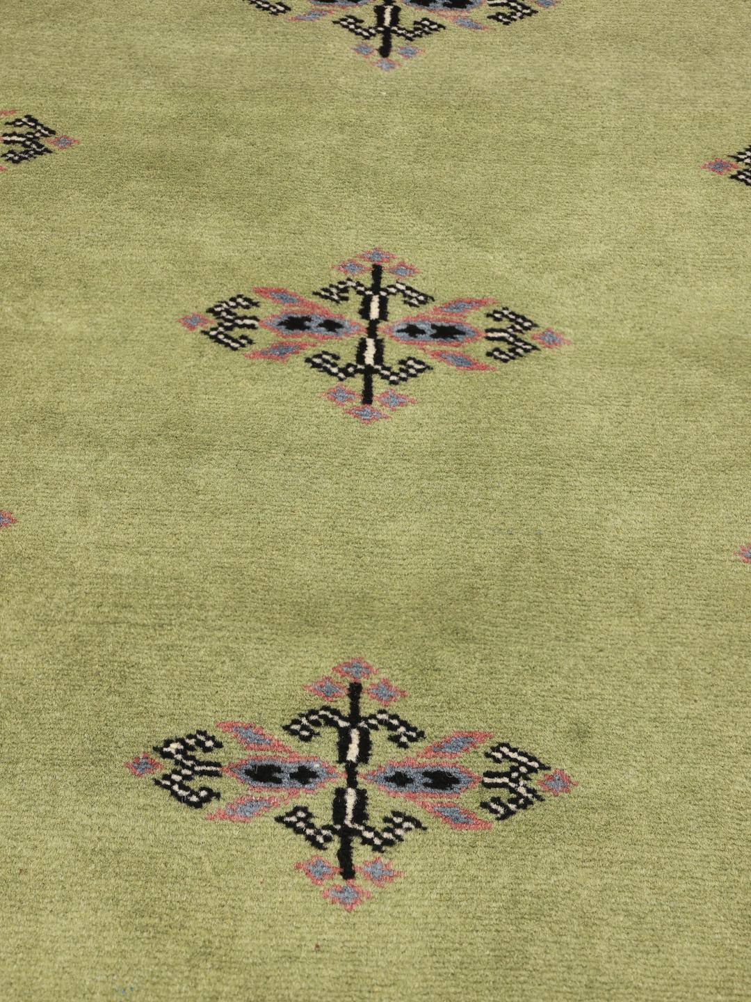 Handmade wool rug from Pakistan in green
