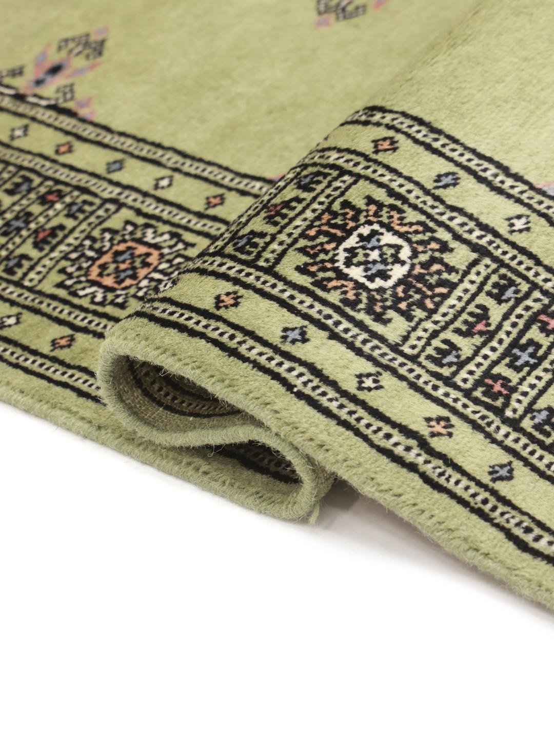Handmade wool rug from Pakistan in green
