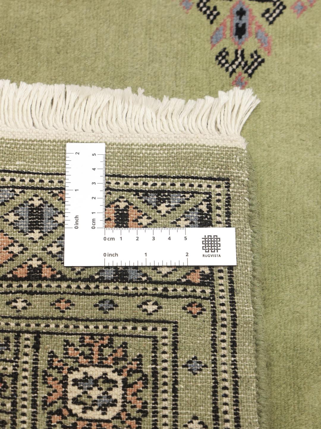 Handmade wool rug from Pakistan in green