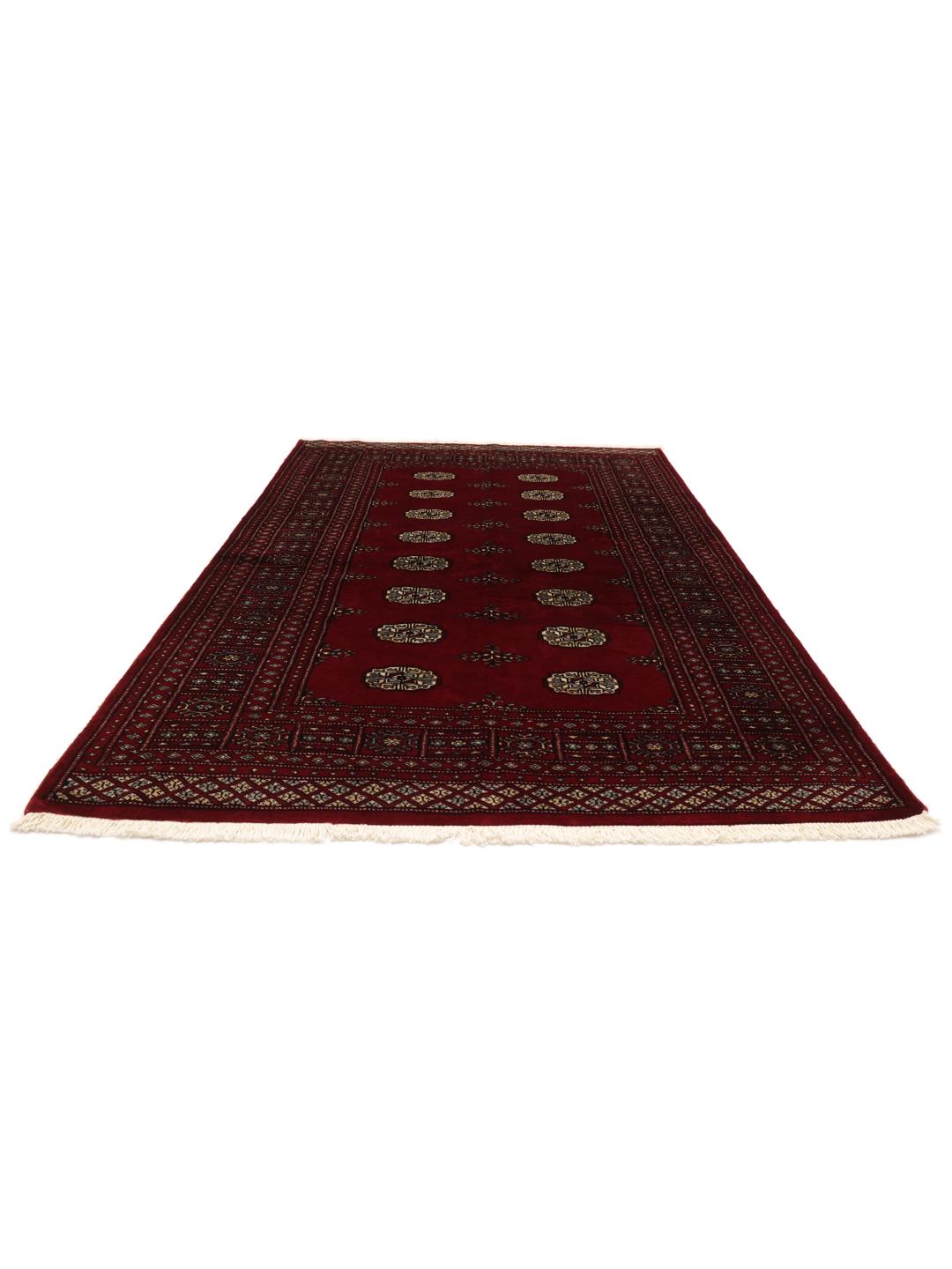 Hand-knotted Pakistani wool rug in dark-red with traditional geometric patterns