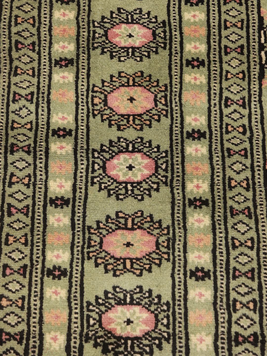 Green Pakistan rug with traditional motifs