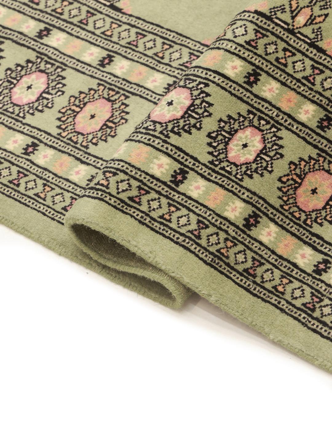 Green Pakistan rug with traditional motifs
