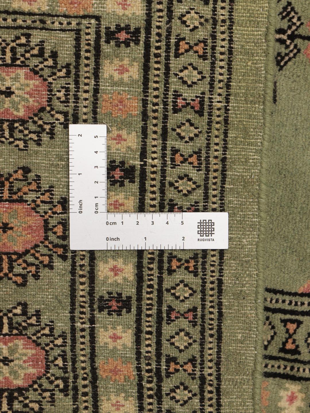 Green Pakistan rug with traditional motifs