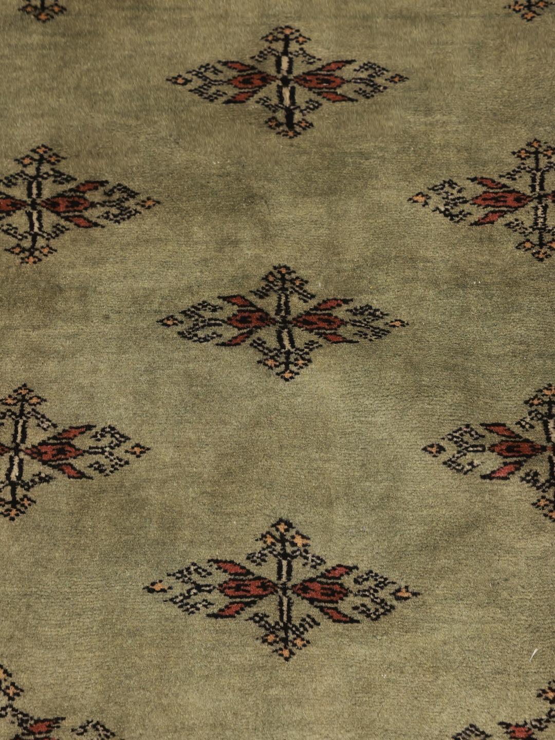 Handmade Pakistani rug in light-green with traditional motifs