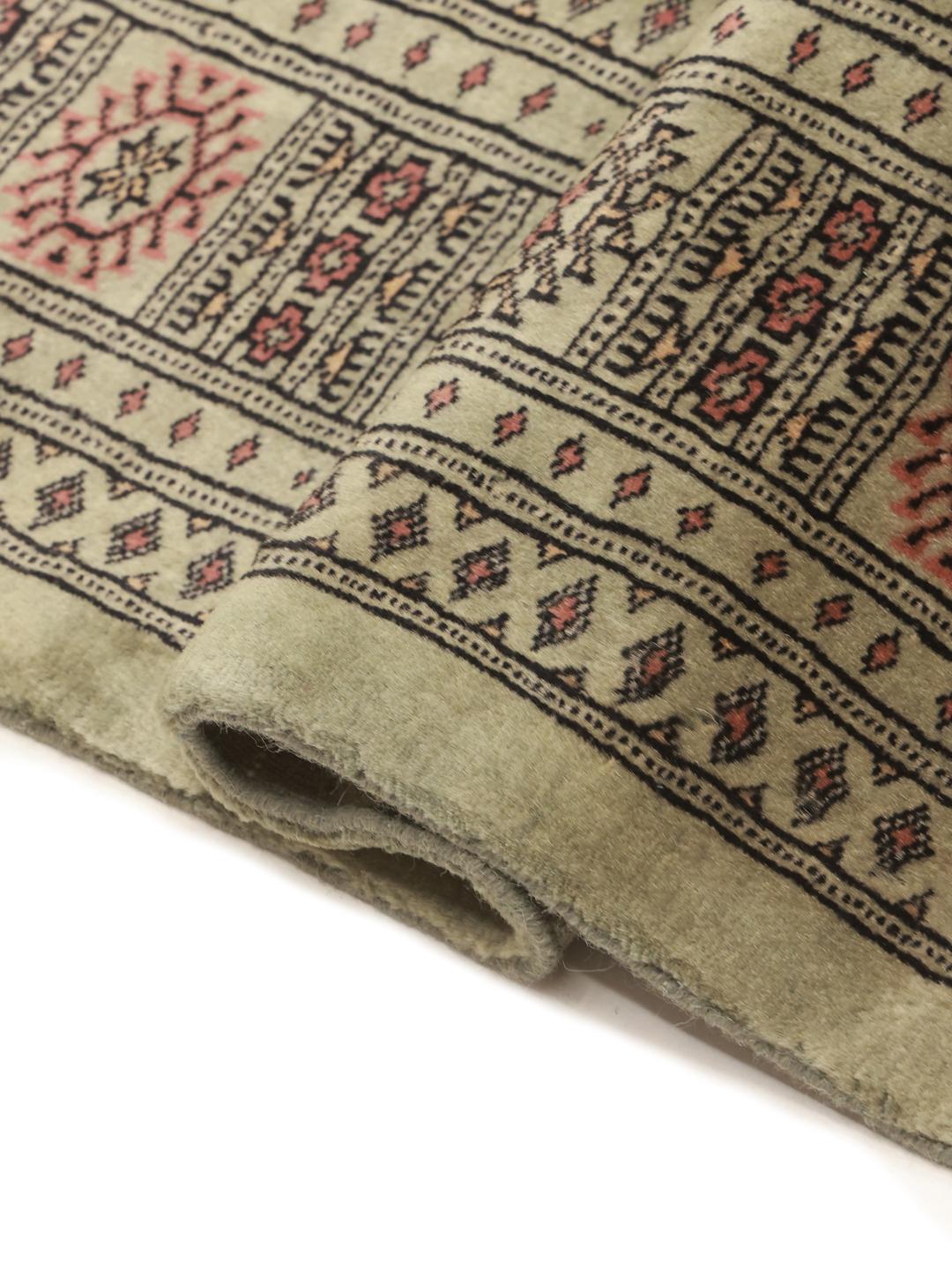 Handmade Pakistani rug in light-green with traditional motifs