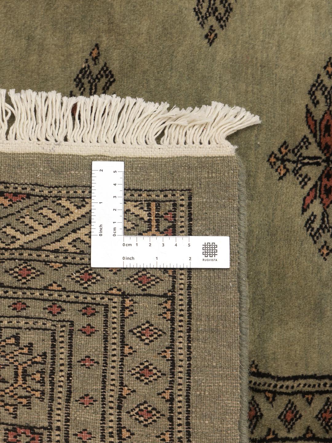 Handmade Pakistani rug in light-green with traditional motifs