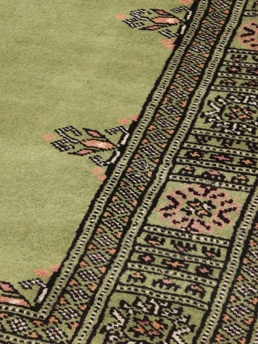 Handmade Pakistan rug in light-green with traditional motifs