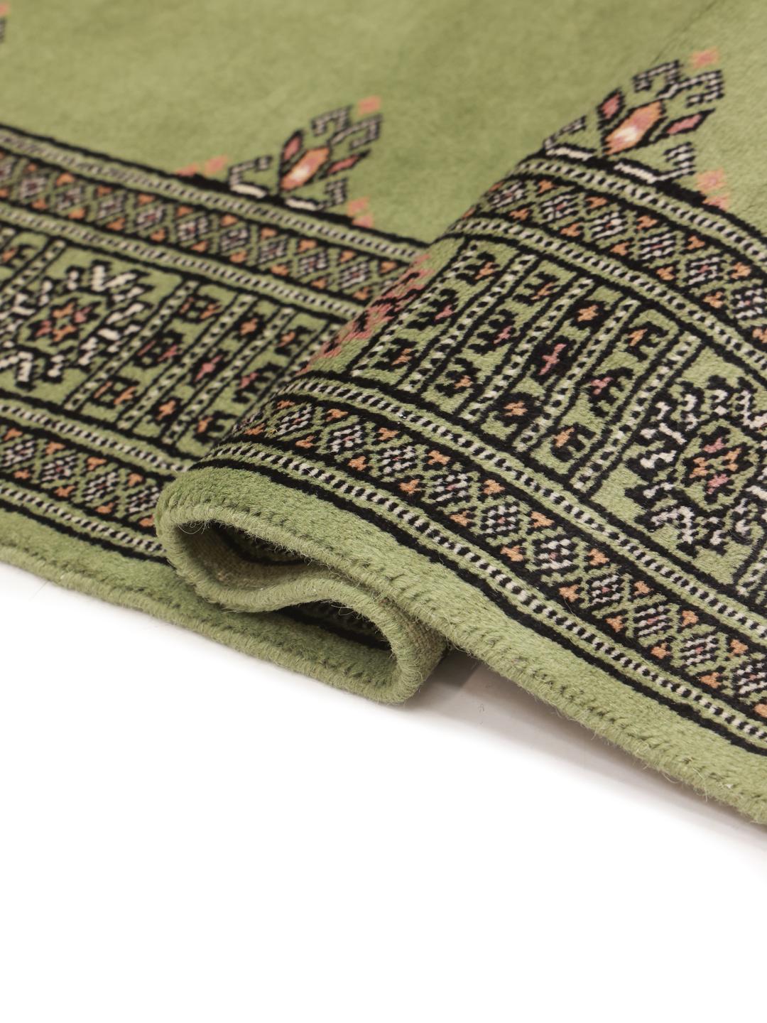 Handmade Pakistan rug in light-green with traditional motifs