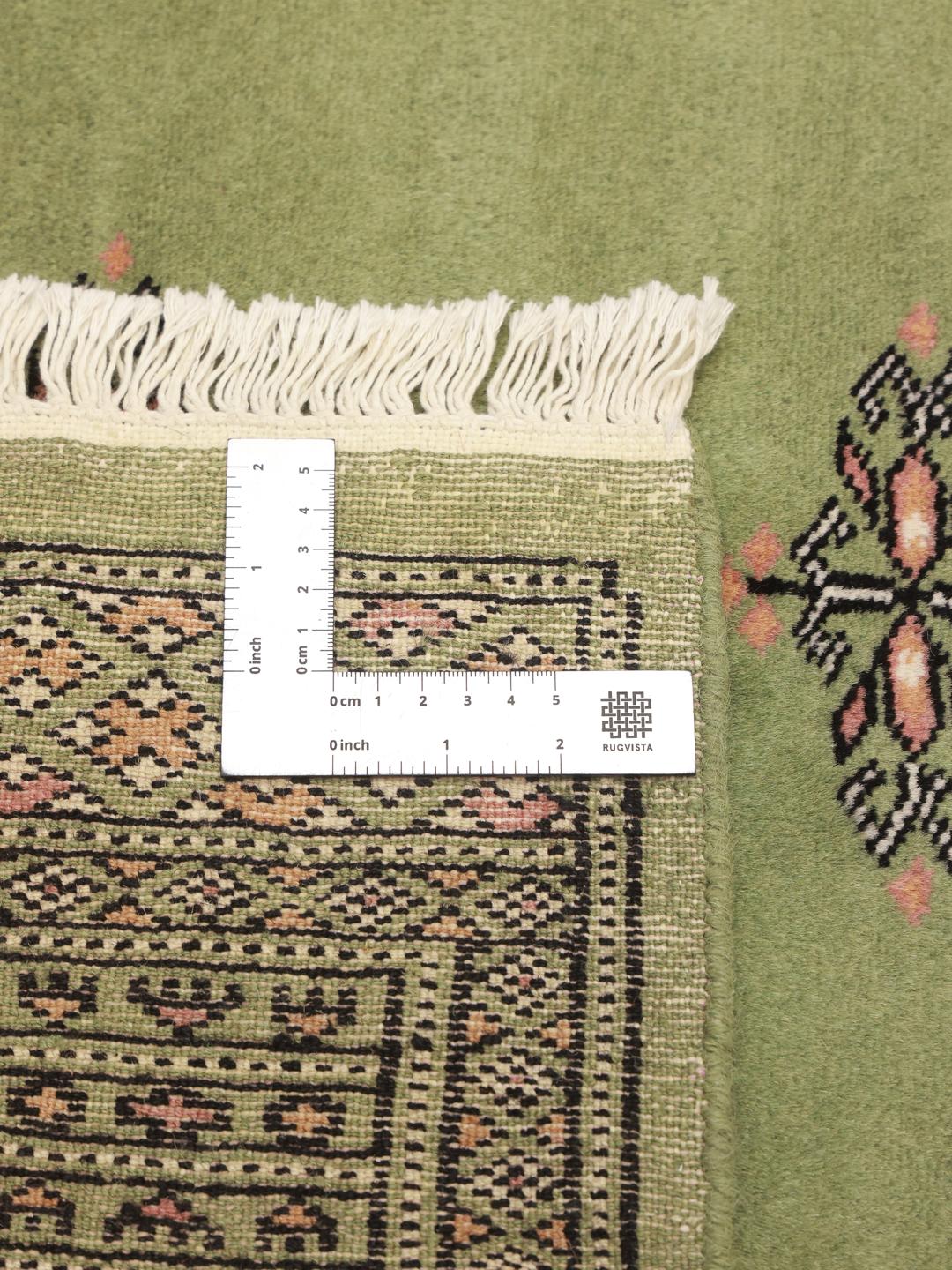 Handmade Pakistan rug in light-green with traditional motifs