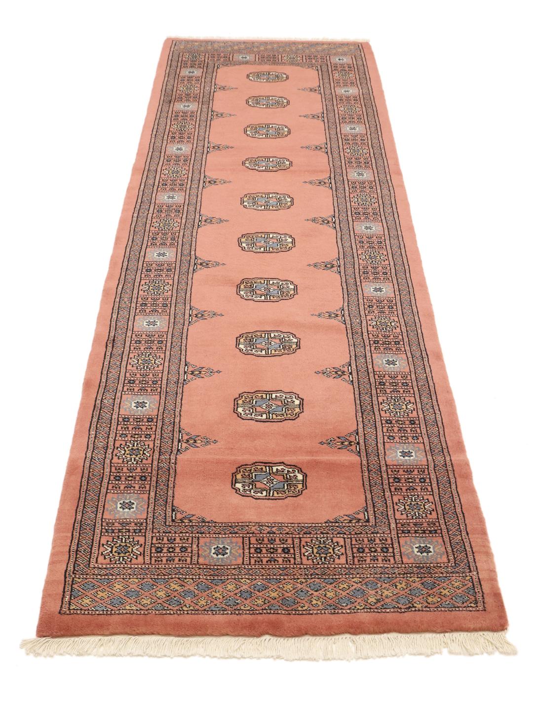 Handmade runner rug from Pakistan in dark red