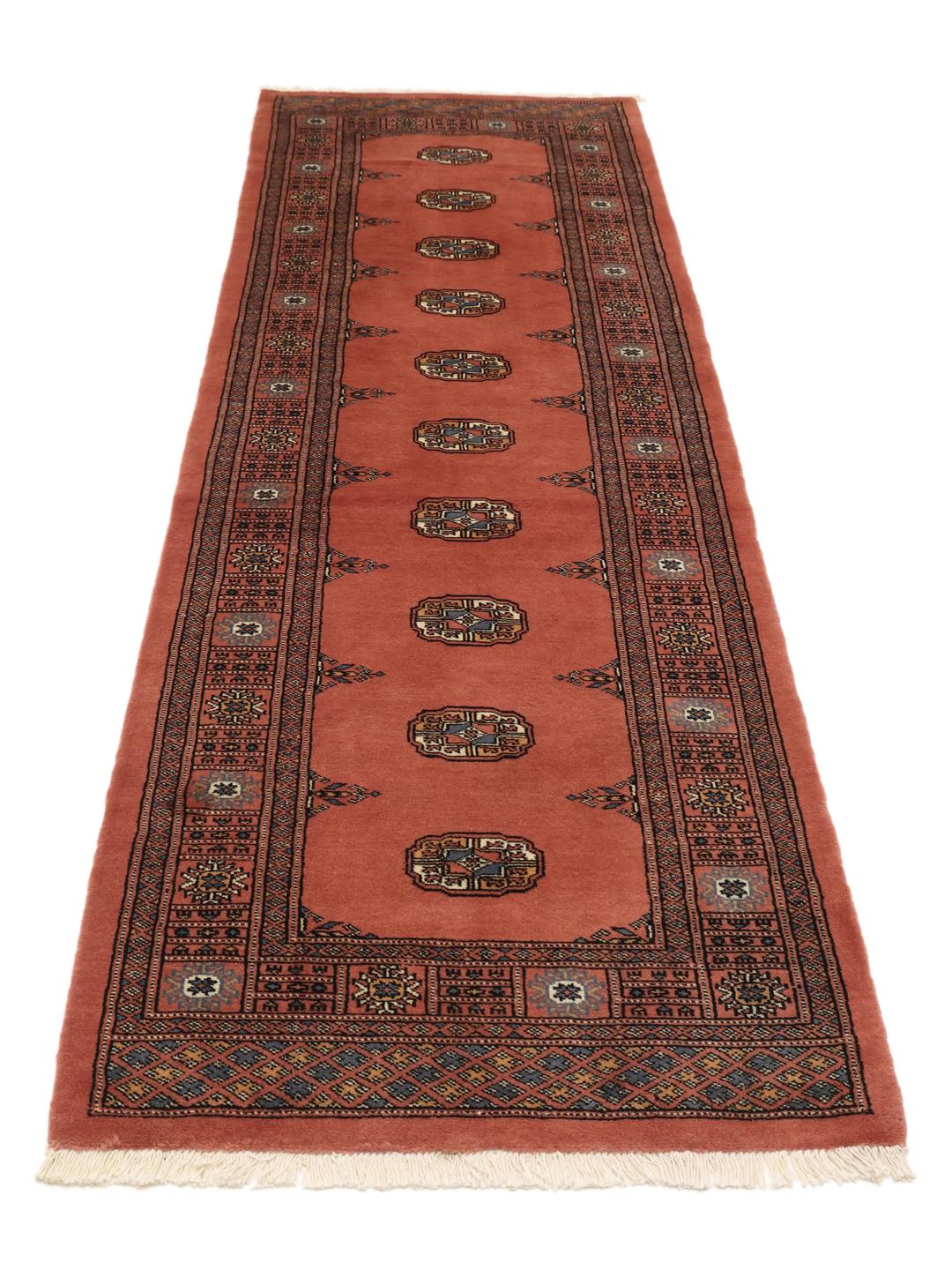 Handmade runner rug from Pakistan in dark red