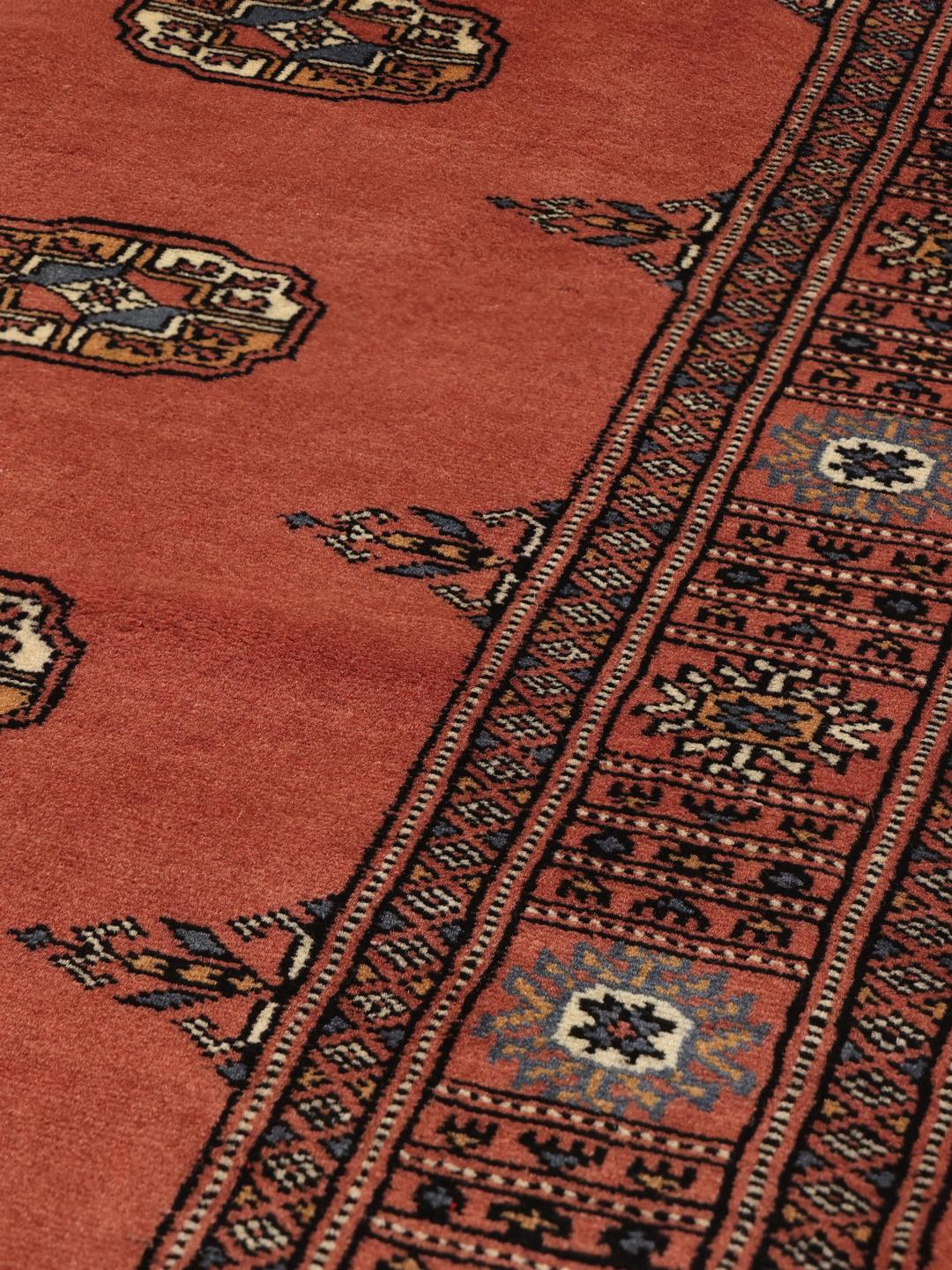 Handmade runner rug from Pakistan in dark red