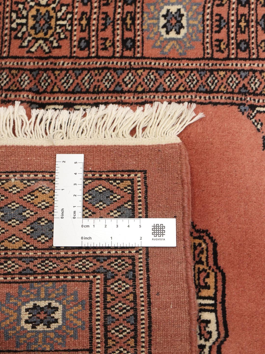 Handmade runner rug from Pakistan in dark red
