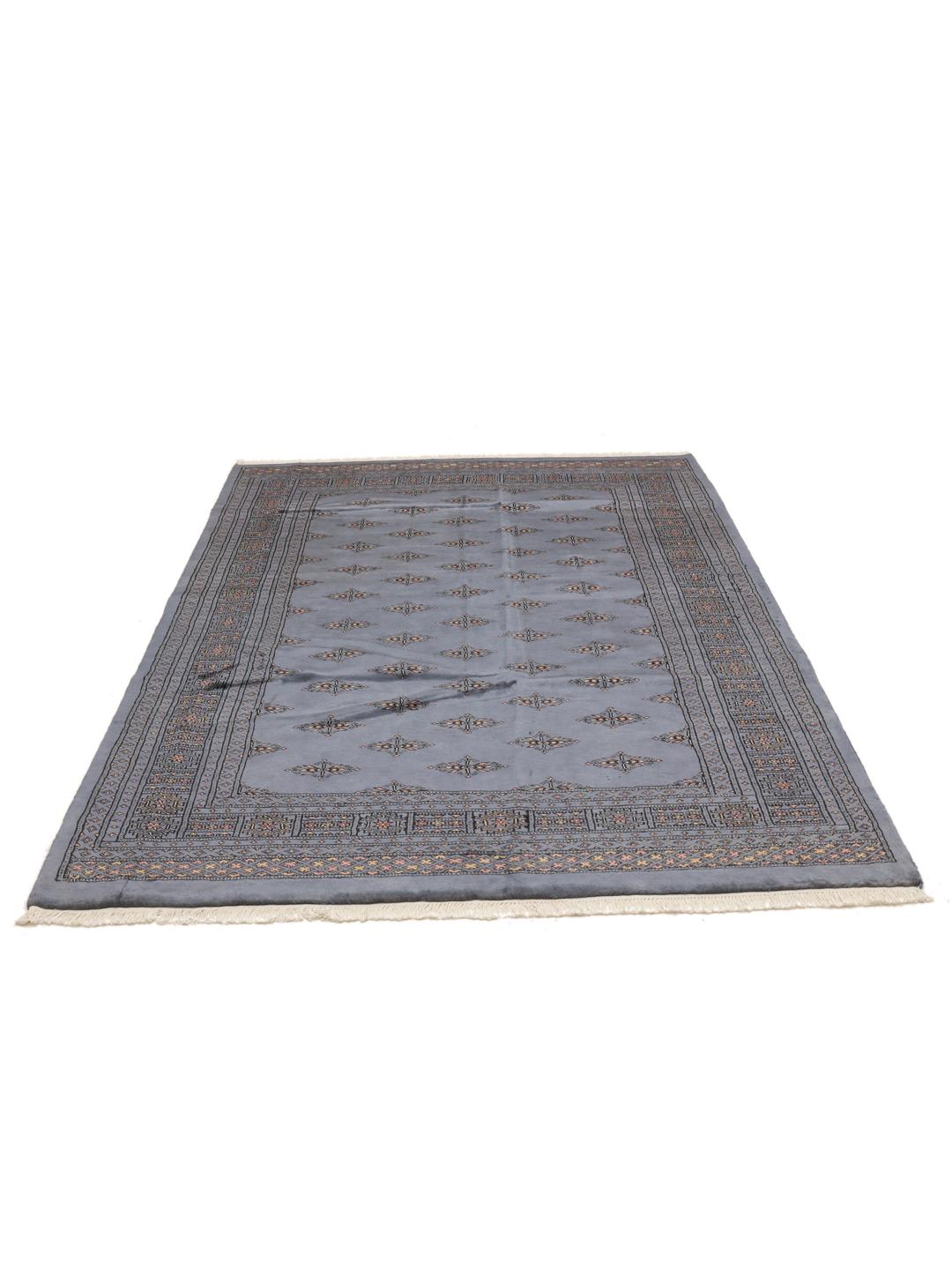 Handmade Pakistan wool rug in blue with traditional patterns